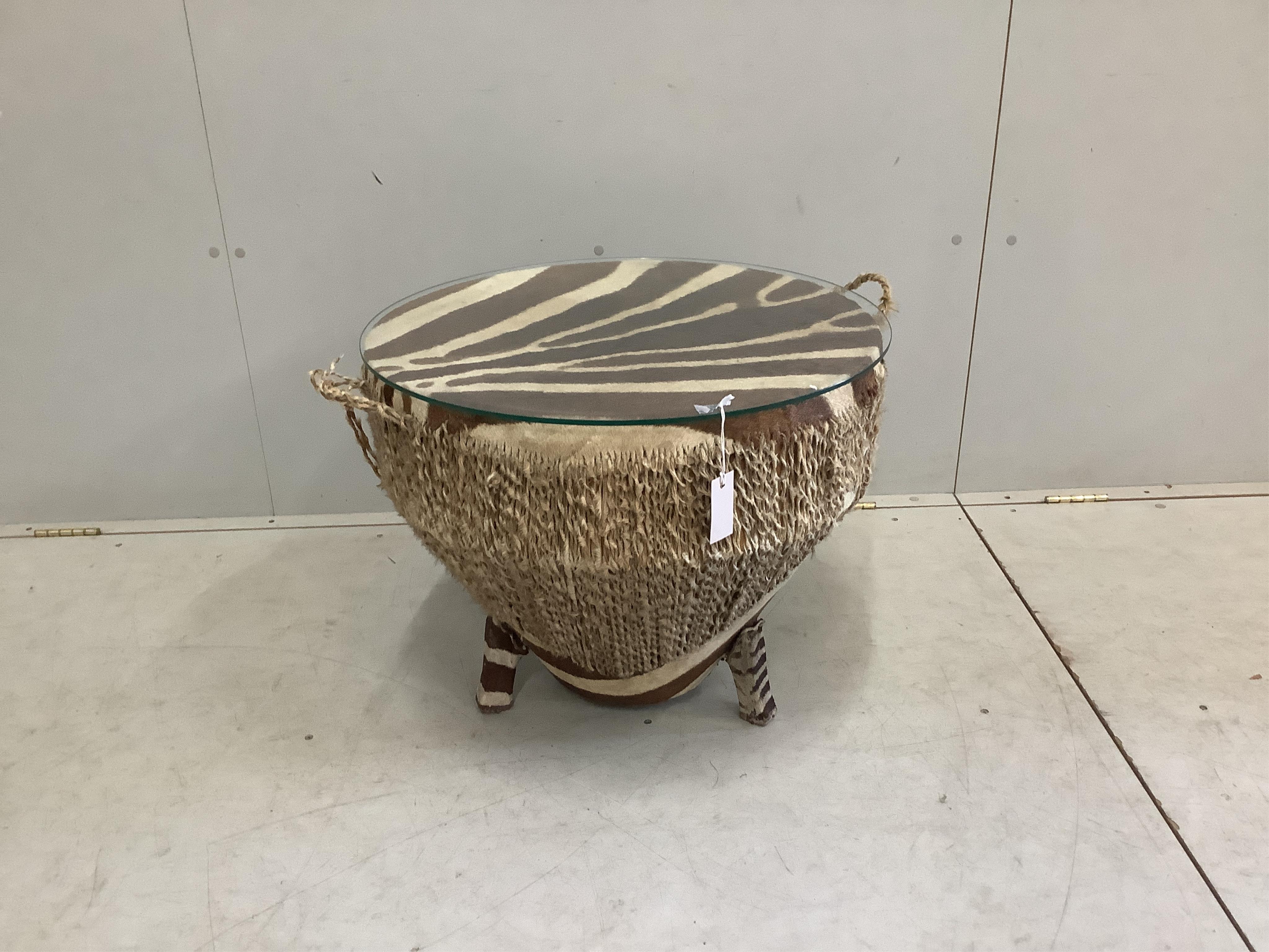 An African zebra skin drum, now as a glass top occasional table, diameter 62cm, height 51cm. Condition - fair